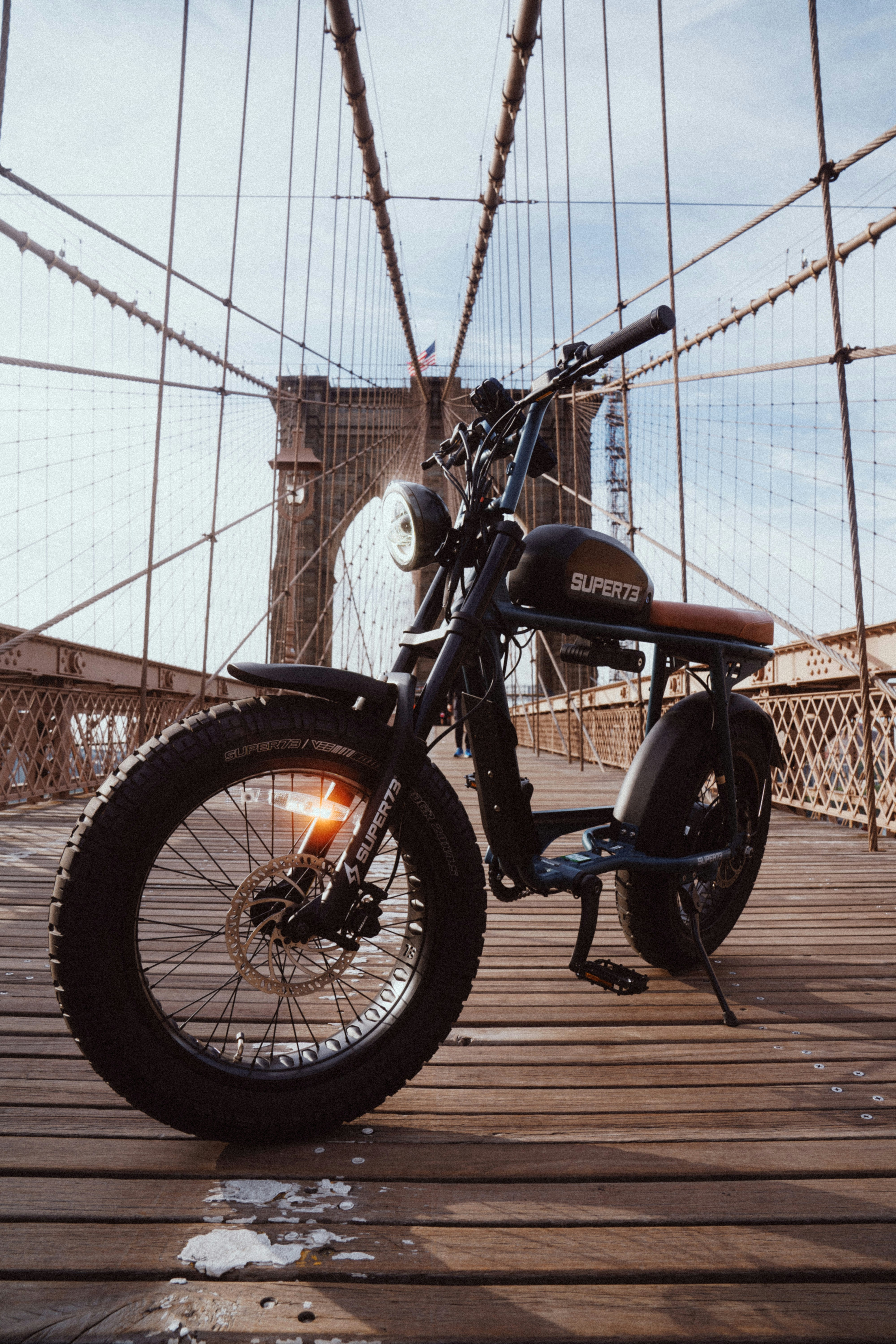 black and red motorcycle parked beside gray concrete wall